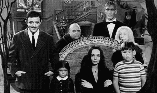 the members of the Addams family from the 1960s TV show all snapping their fingers