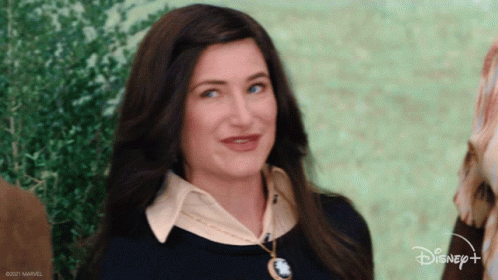 Actress Kathryn Hahn does a dramatic wink and grins at the camera cheekily.