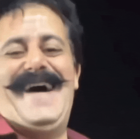 Gif de um homem de bigode, estilo tiozão rindo meio sem graça