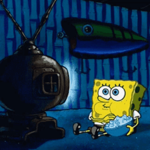 Imagem é um gif do Bob Esponja comendo pipoca e assistindo TV